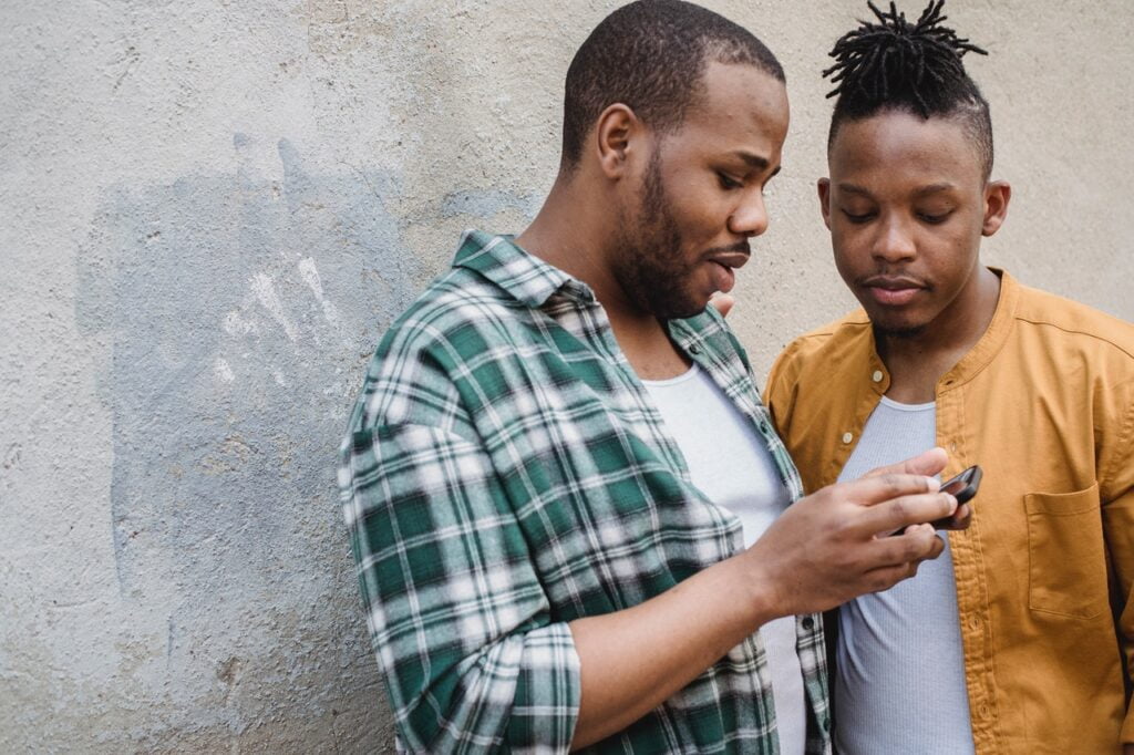 men looking at phone