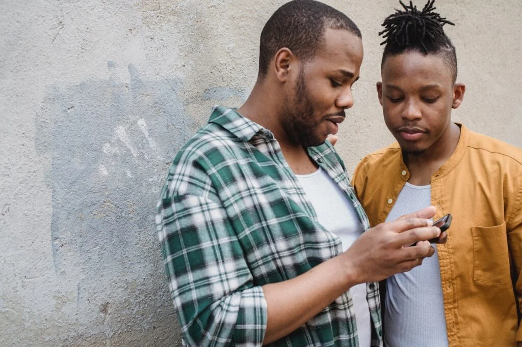 men looking at phone